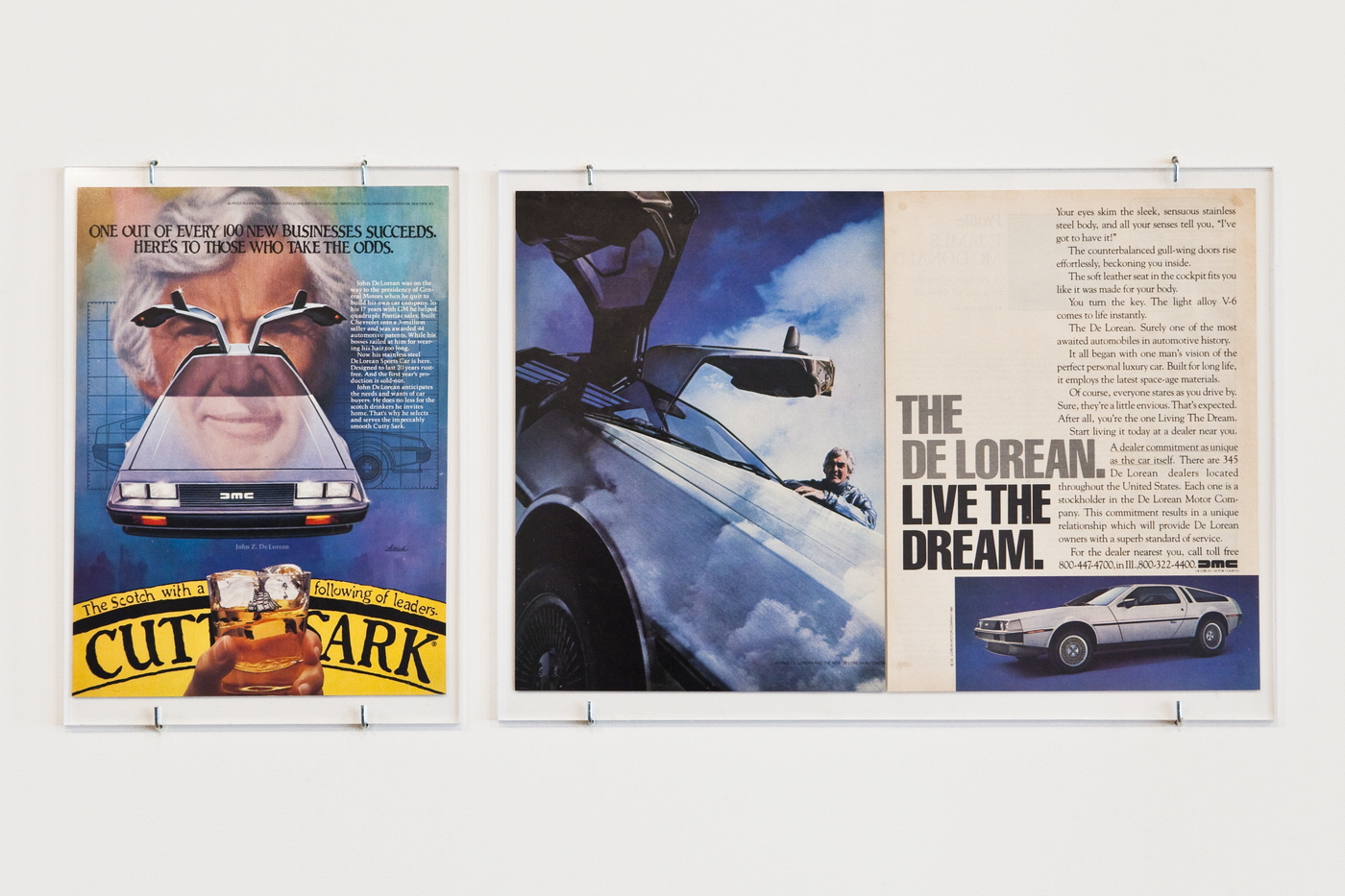 Two side-by-side magazine advertisements mounted on a white wall. On the left, a portrait-oriented multicolored image is titled, 