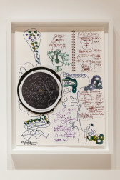 A color photograph of a mixed media collage with various drawings and handwritten text in a white frame.
