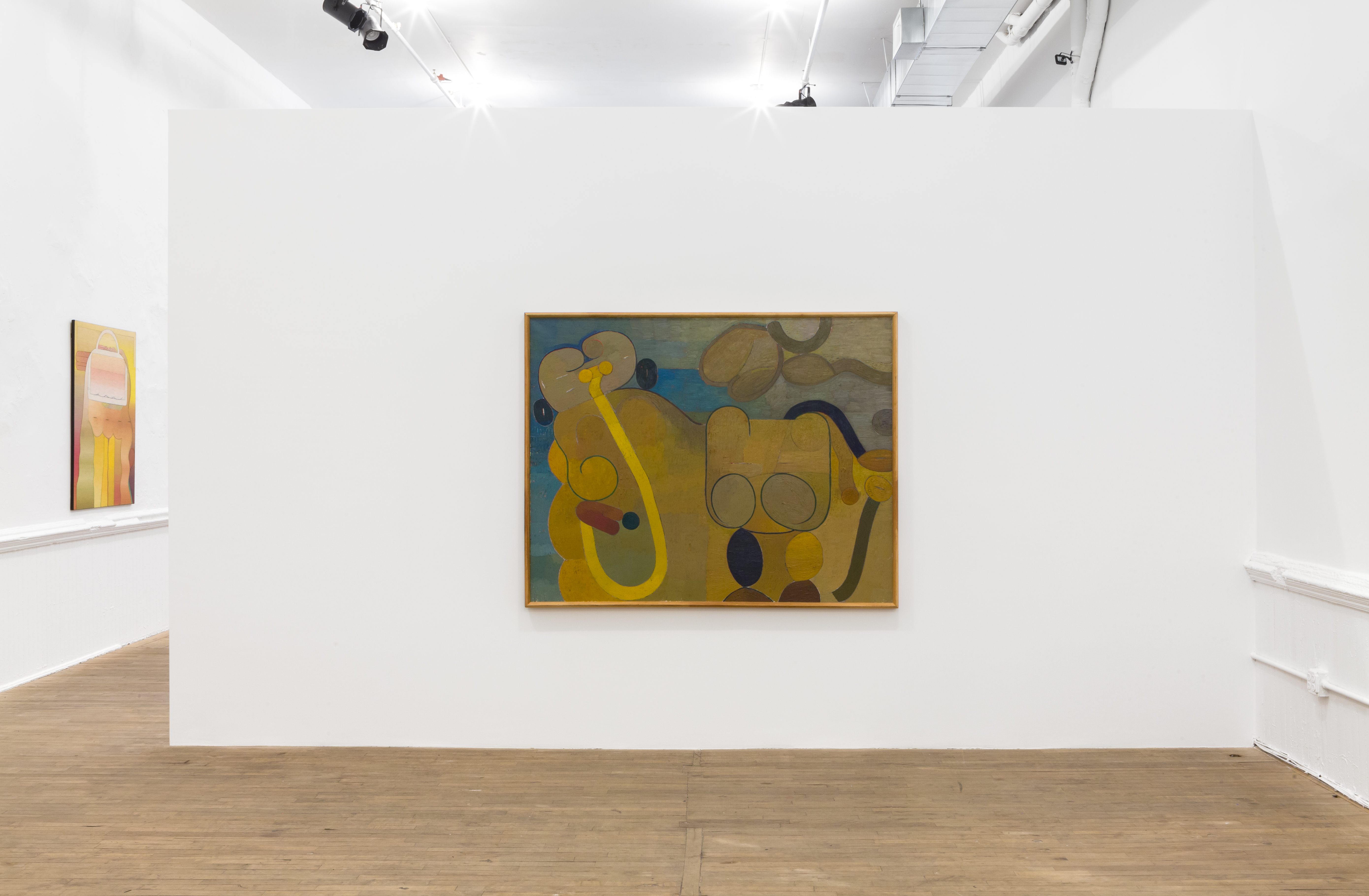 A painting with blue, yellow, and neutral tones is hung on a white wall. Another painting is visible in the background with bright yellow and orange hues.