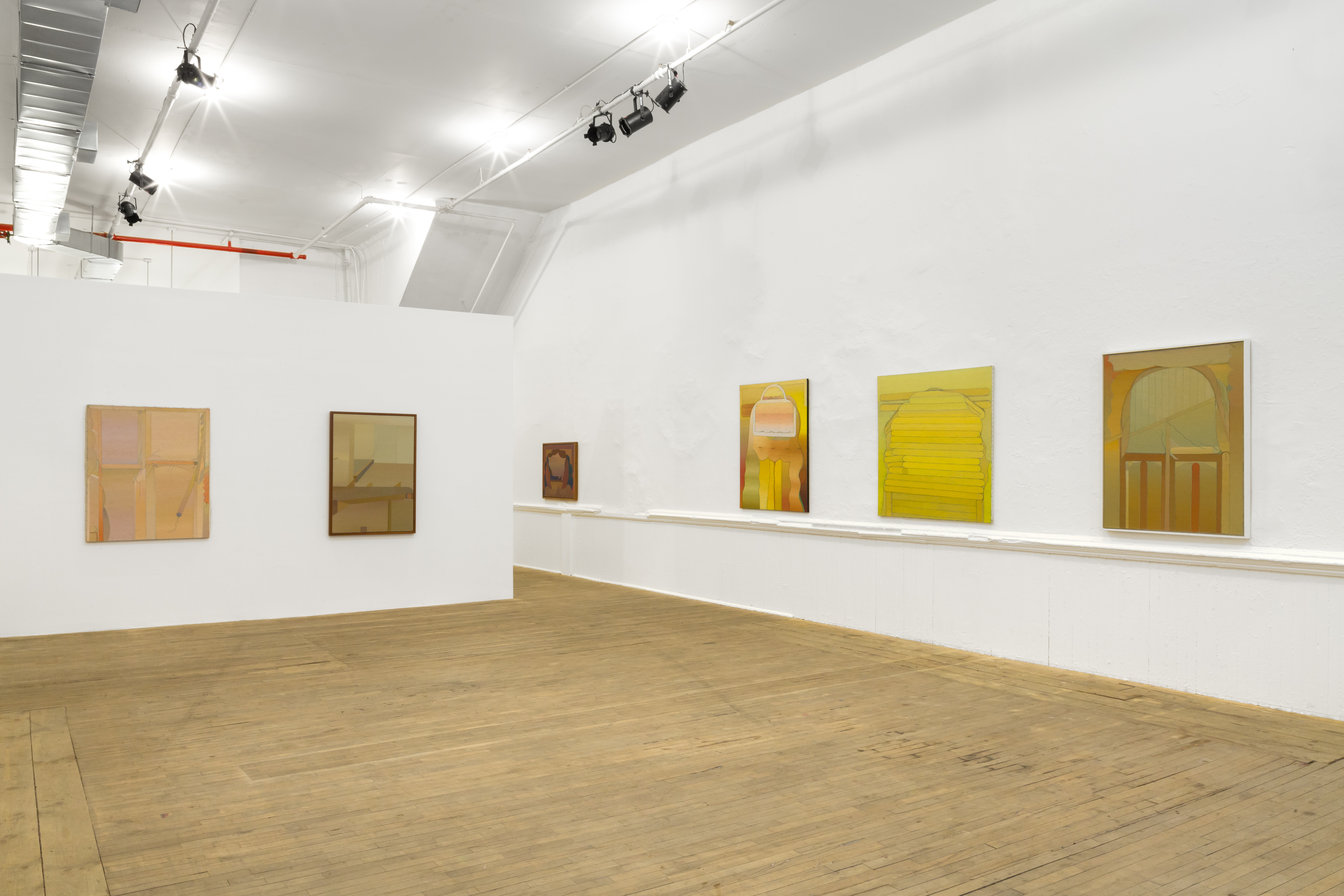 Six paintings are hung on white walls at eye level. The paintings contain muted and vibrant warm colors depicting abstract shapes.