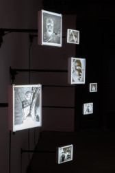 An image of photograph negatives with LED lightboxes hanging off a wall.