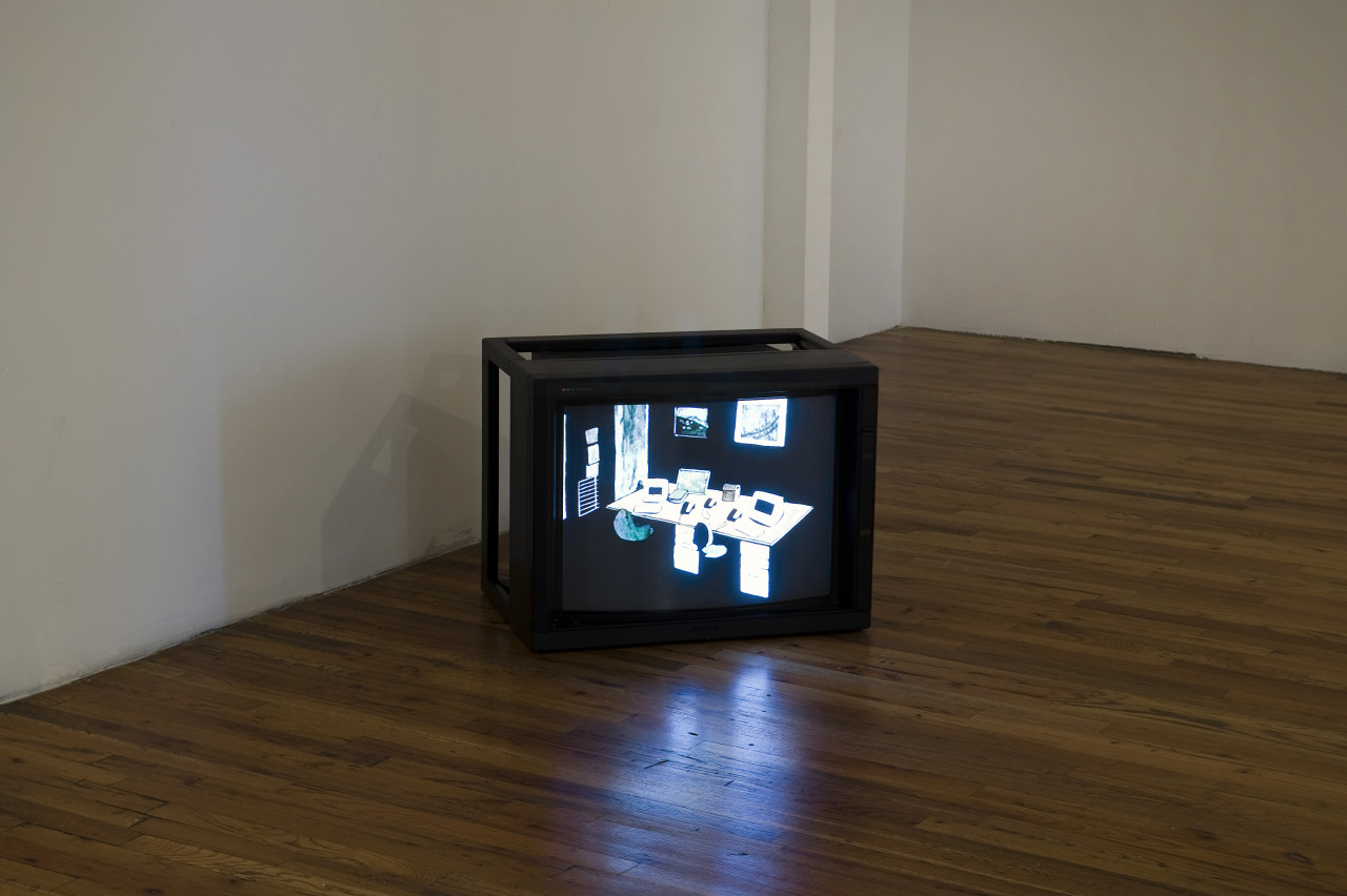 A rectangular television sits on the wooden floor near the wall. The high-contrast image on the TV shows another room with a long table upon which are computers, phones, and other office equipment. There are chairs at the desk and images hung on the wall.