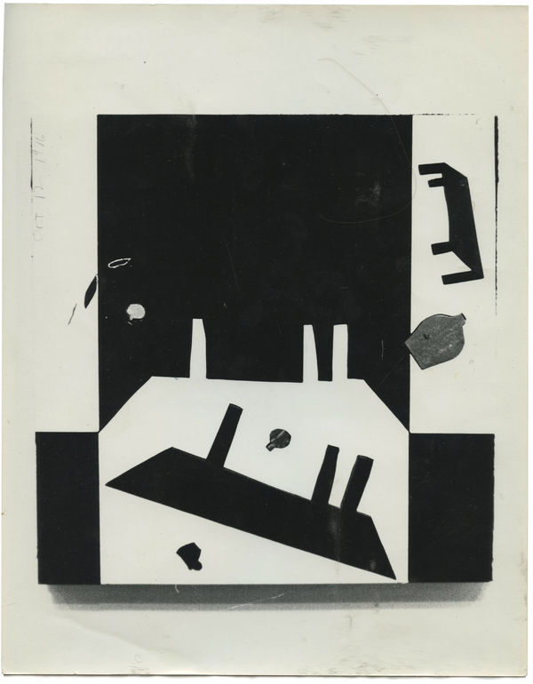A black and white photograph of a canvas filled with black and white abstract angular forms that are reminiscent of tables.