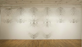A large white wall with symmetric, geometric patterns drawn on it.