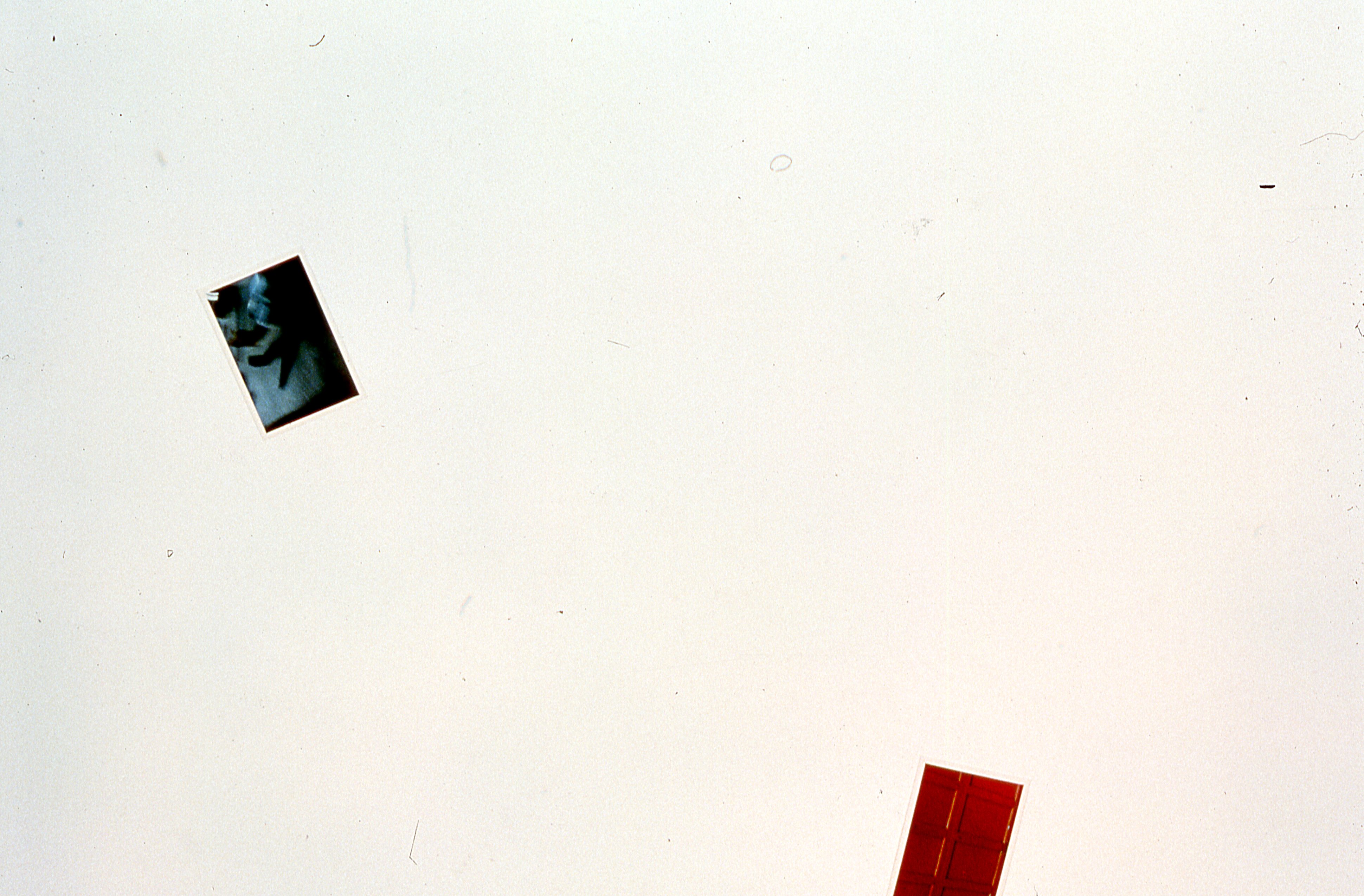 Two photographs are mounted on a white gallery wall.