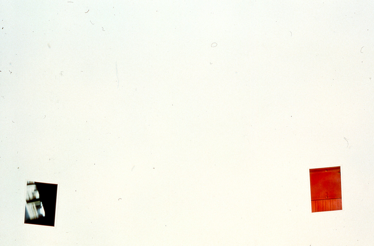 Two photographs are mounted on a white gallery wall.