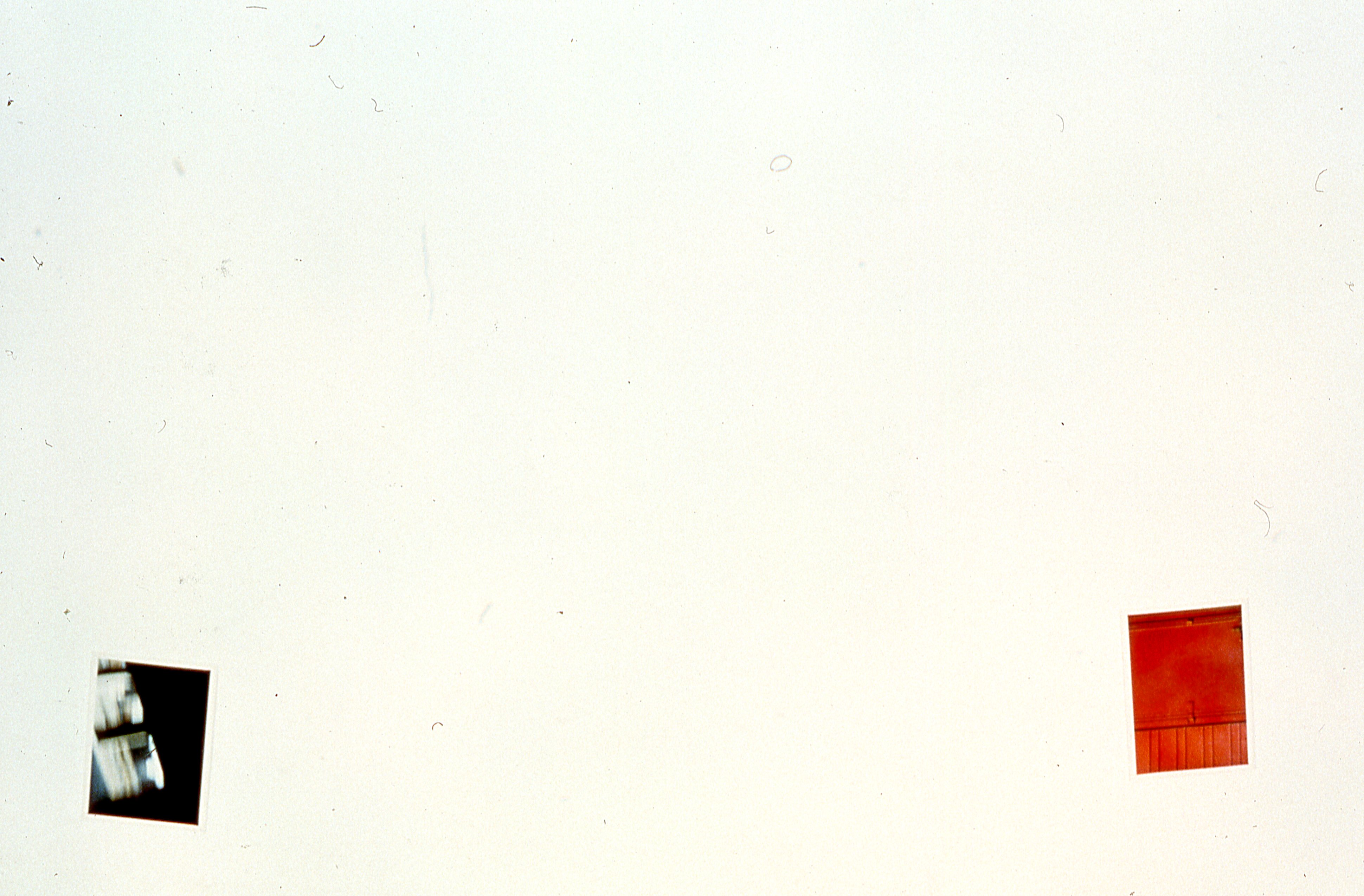 Two photographs are mounted on a white gallery wall.