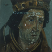 A slightly chipped painting of a face with downcast eyes and a medieval-style crown.  The word 