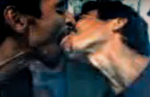 Low res image of two men, with tan skin and curly hair, kissing profusely.
