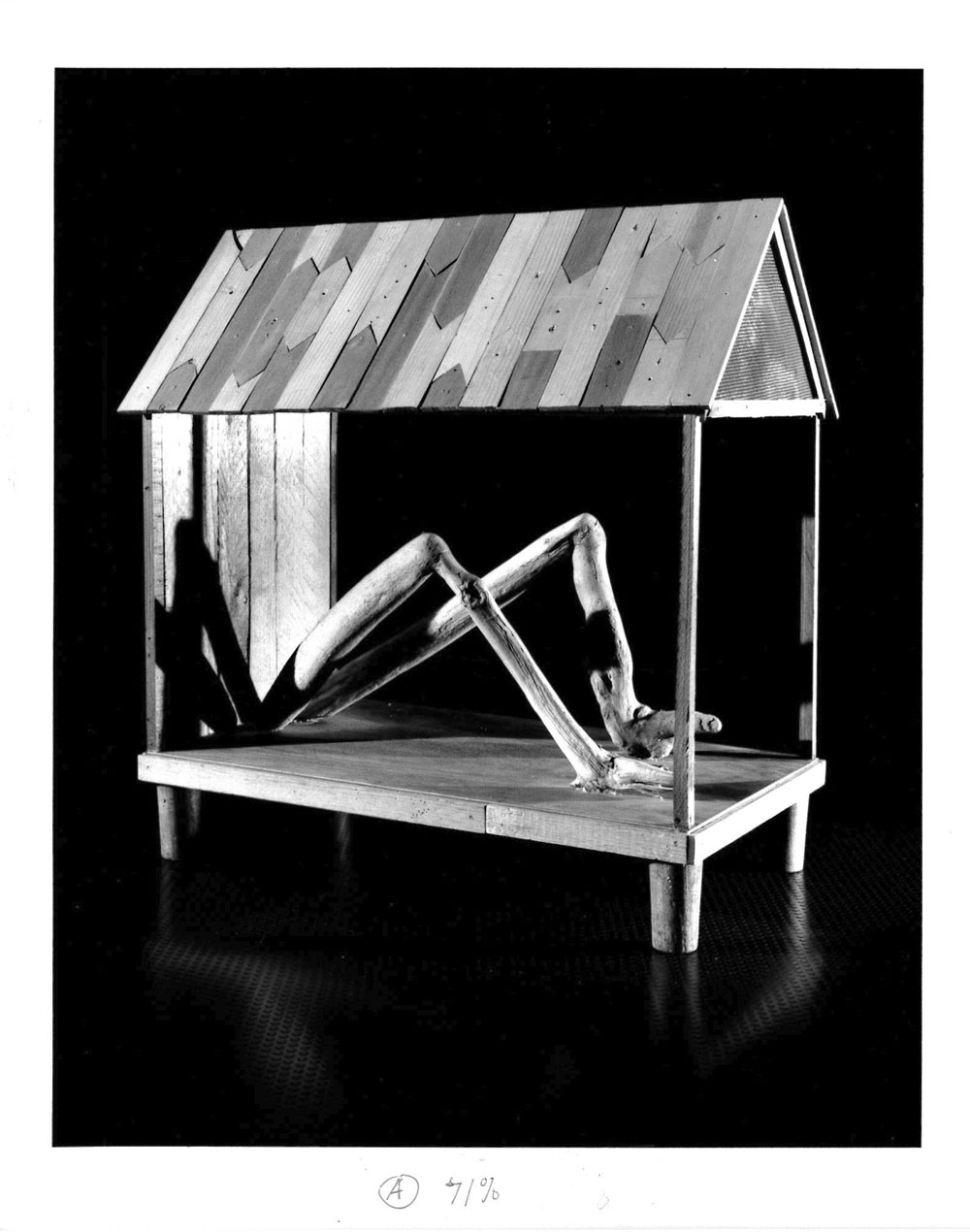 Legs and feet appear from a small wooden dwelling with a black background.