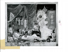 A view of a large amorphous creature with eyes and mouth on the right next to a dwelling space with a figure lying on a bed with clothes and other accoutrements nearby.