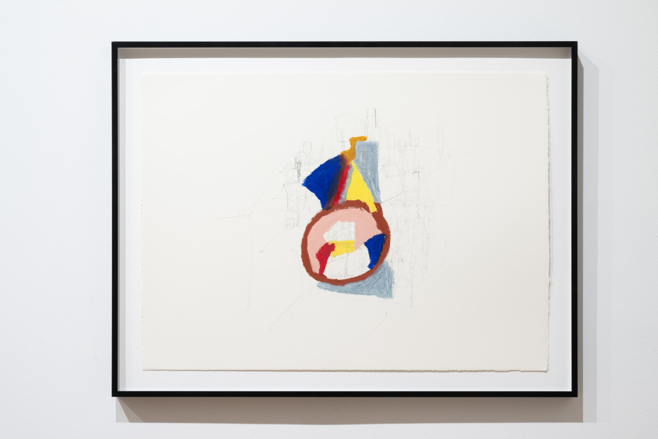 A close-up color image of a framed work displayed against a white wall. The drawing depicts a colorful abstract composition with a brown circle being the main figure from where trianagles and lines emerge. Soft pencil strokes complement the composition.