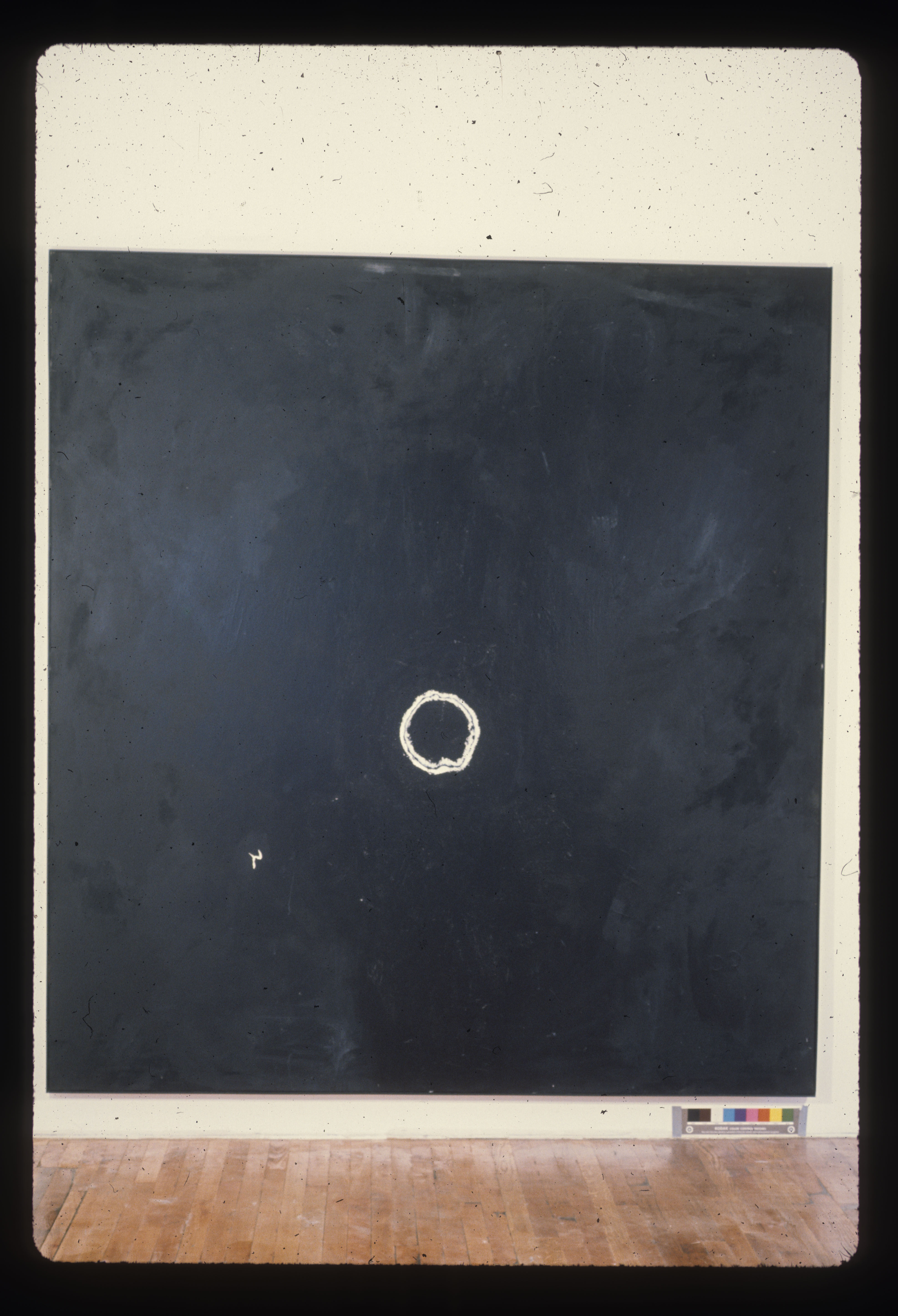 A color installation photograph of a black and white abstract painting on a white wall.