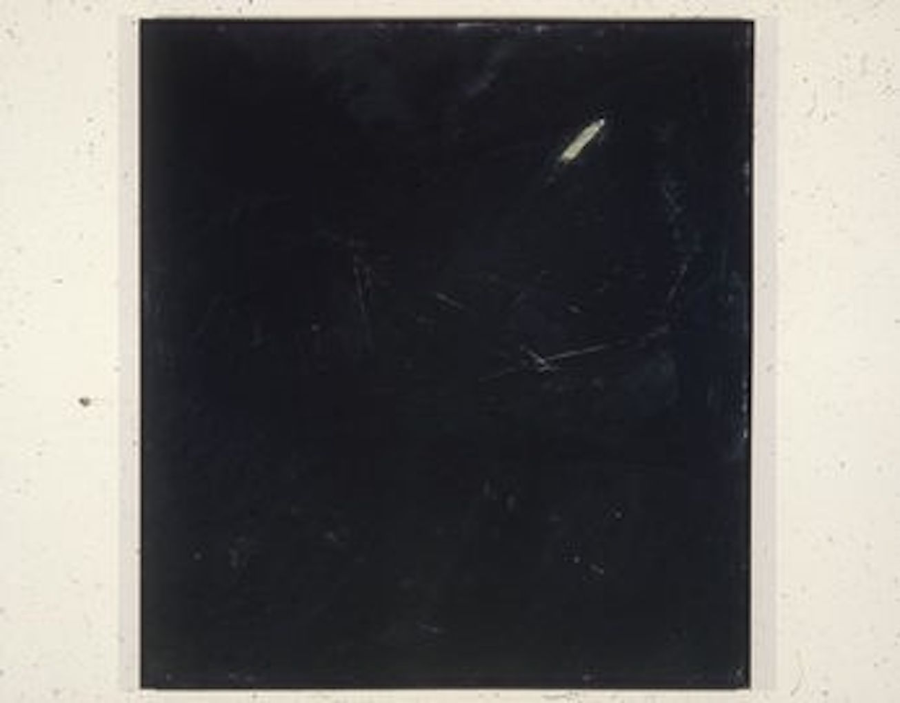 A color installation photograph of a black and white abstract painting on a white wall.