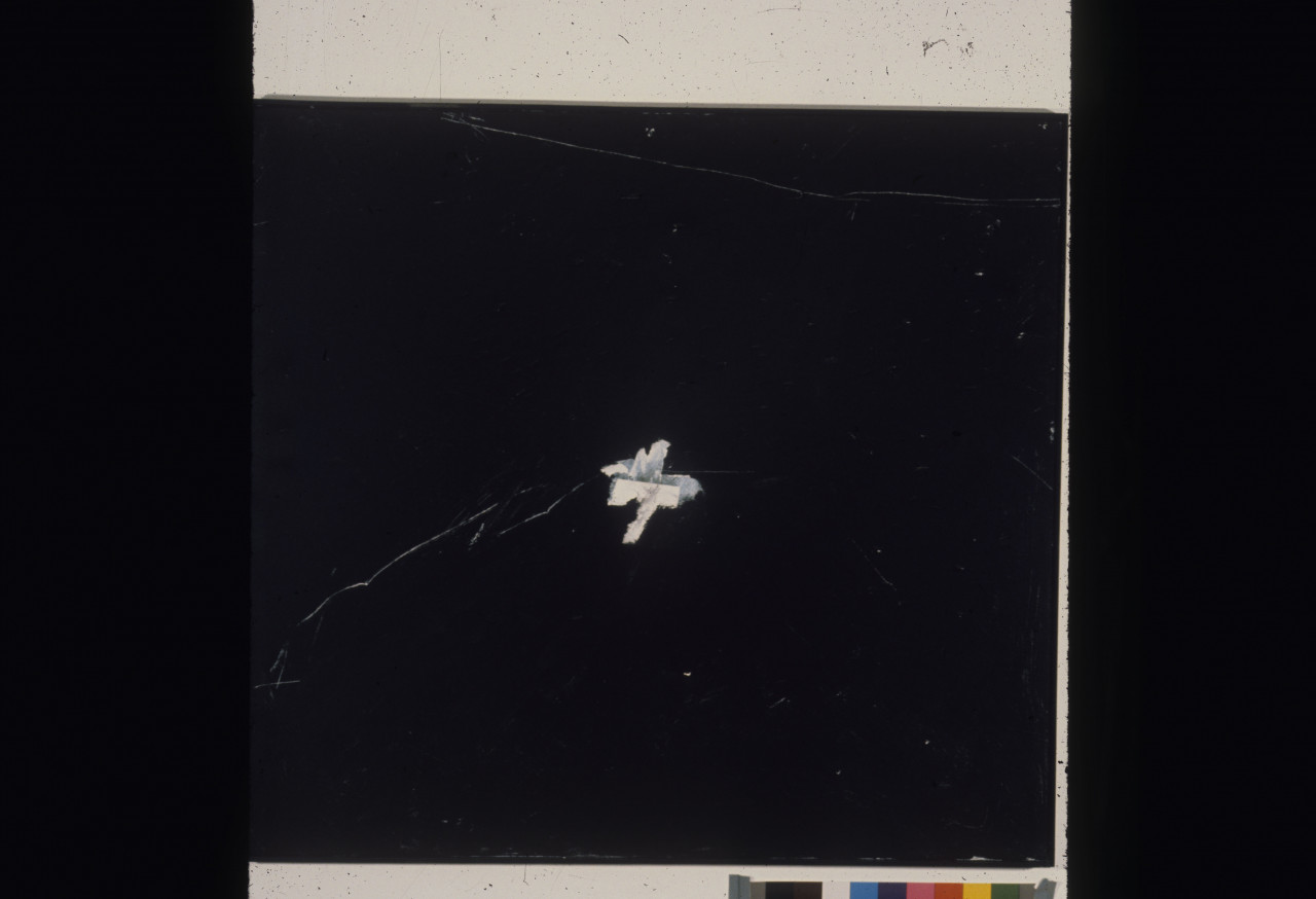 A color installation photograph of a black and white abstract painting on a white wall.