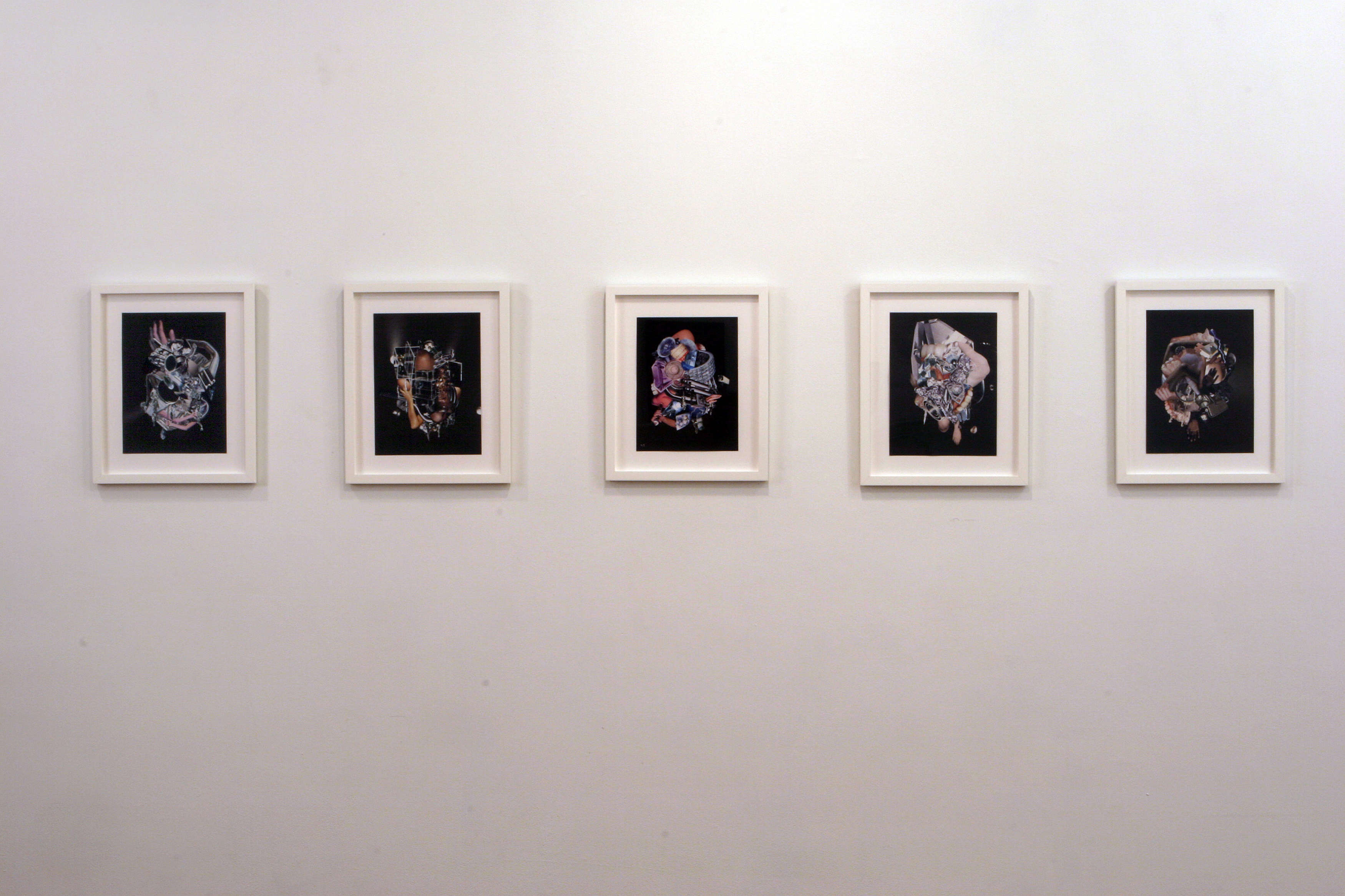 Five photographic collages installed in white frames arranged in a horizontal row along a blank wall.