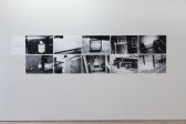 Ten black and white photographs arranged in a rectangle on a white wall. The images show various scenes of assorted trash on streets.
