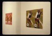 Two split screen image photographs hang on a white gallery wall, the one closer has an image of a monkey dressed in a sports suit with a soccer ball on a field. The other image in the background shows a kitten with its eyes closed under a blanket. Both images of figures appear identicial.