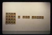 A number of framed images appear on the wall, on the left there is an organized section of 16 and 8 are hung horizontally next to that grouping.