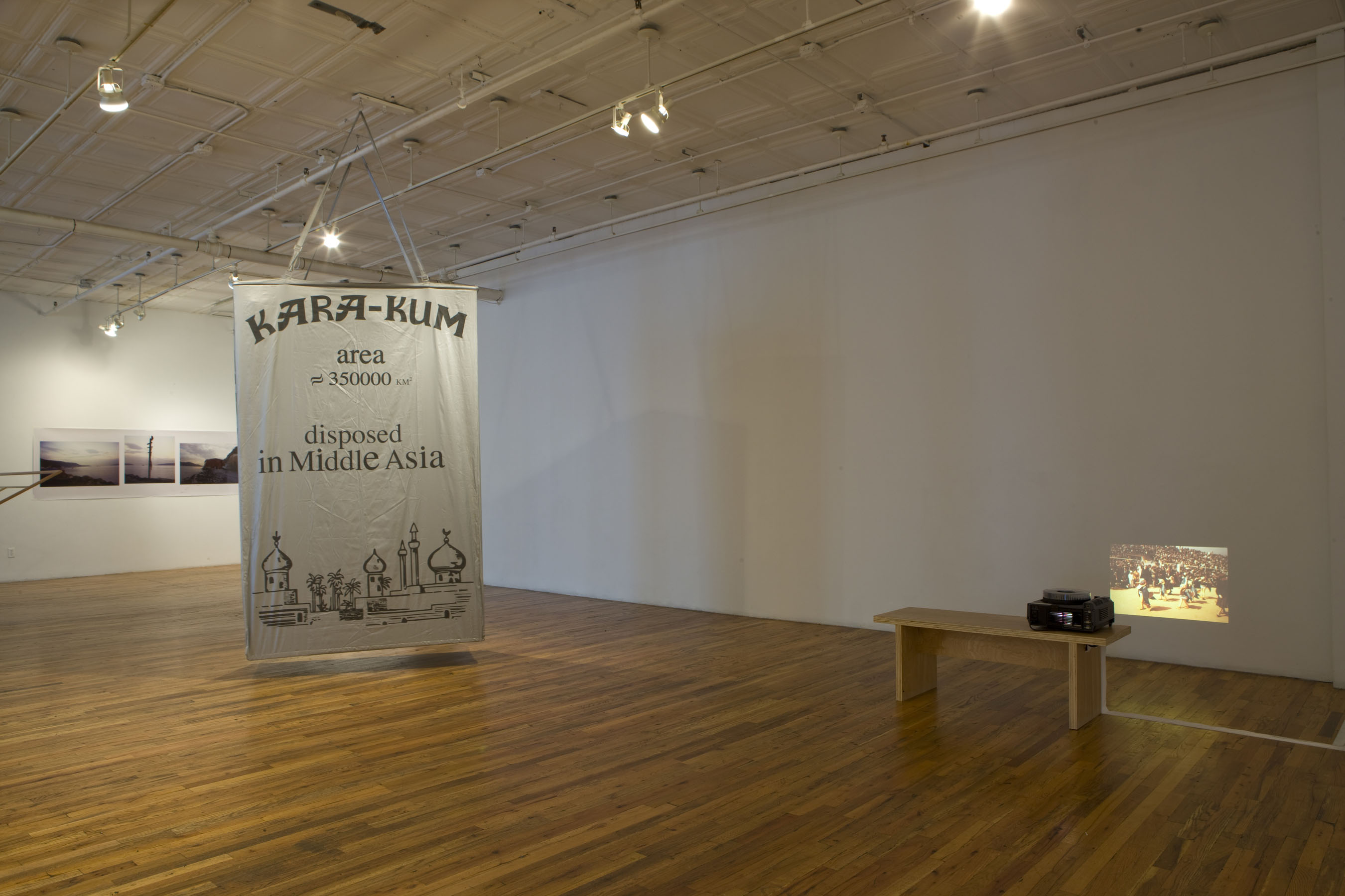 A white cloth banner hangs vertically from the ceiling, with text which reads 