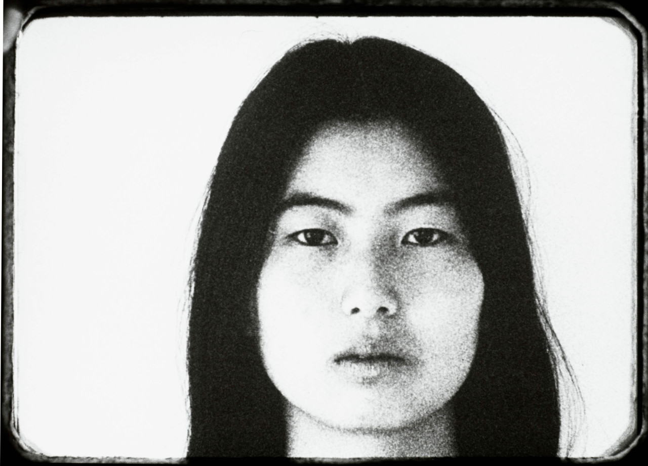 Black-and-white still of a woman