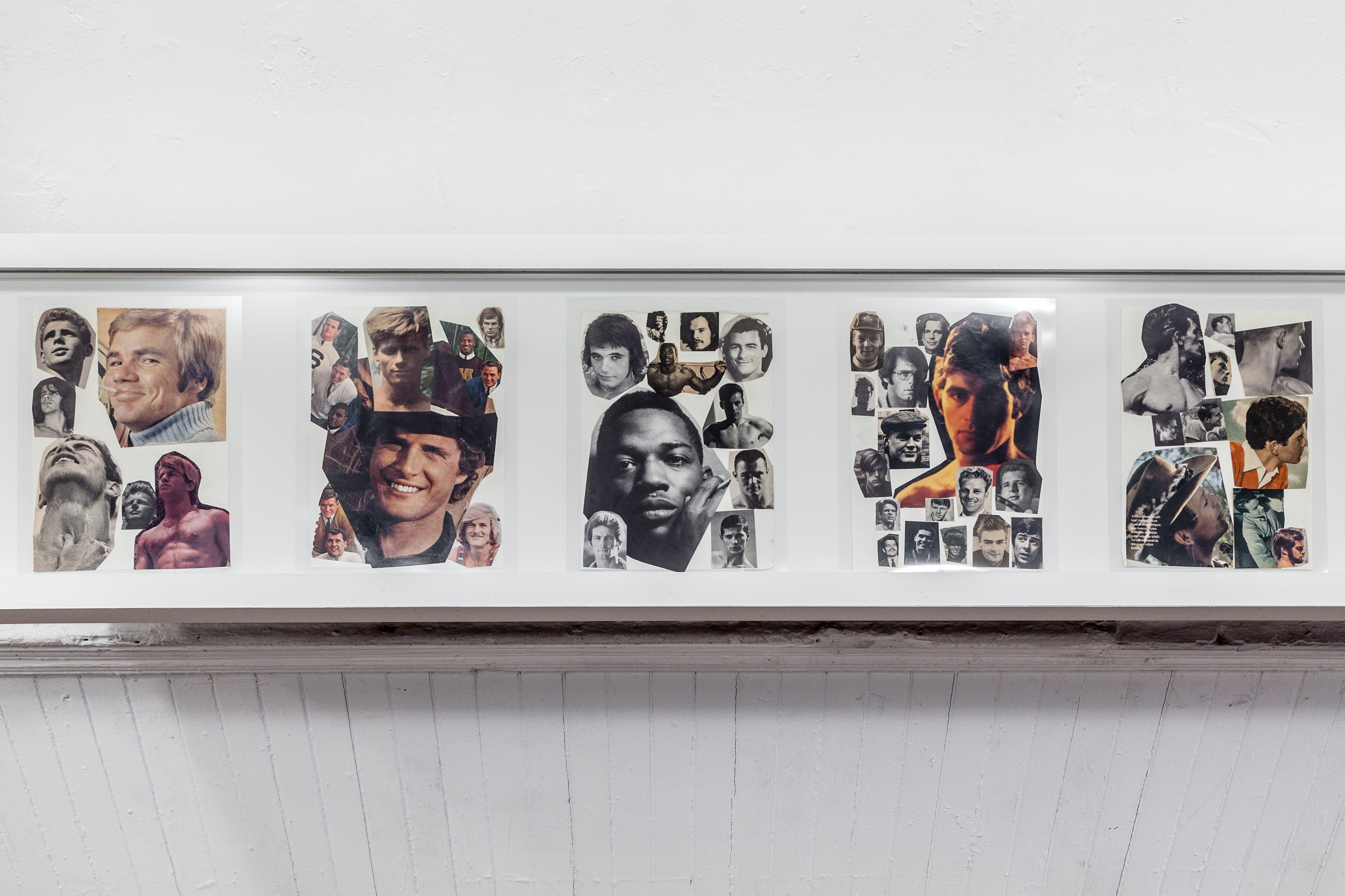 A book case displaying 5 paper collages of men's portraits.