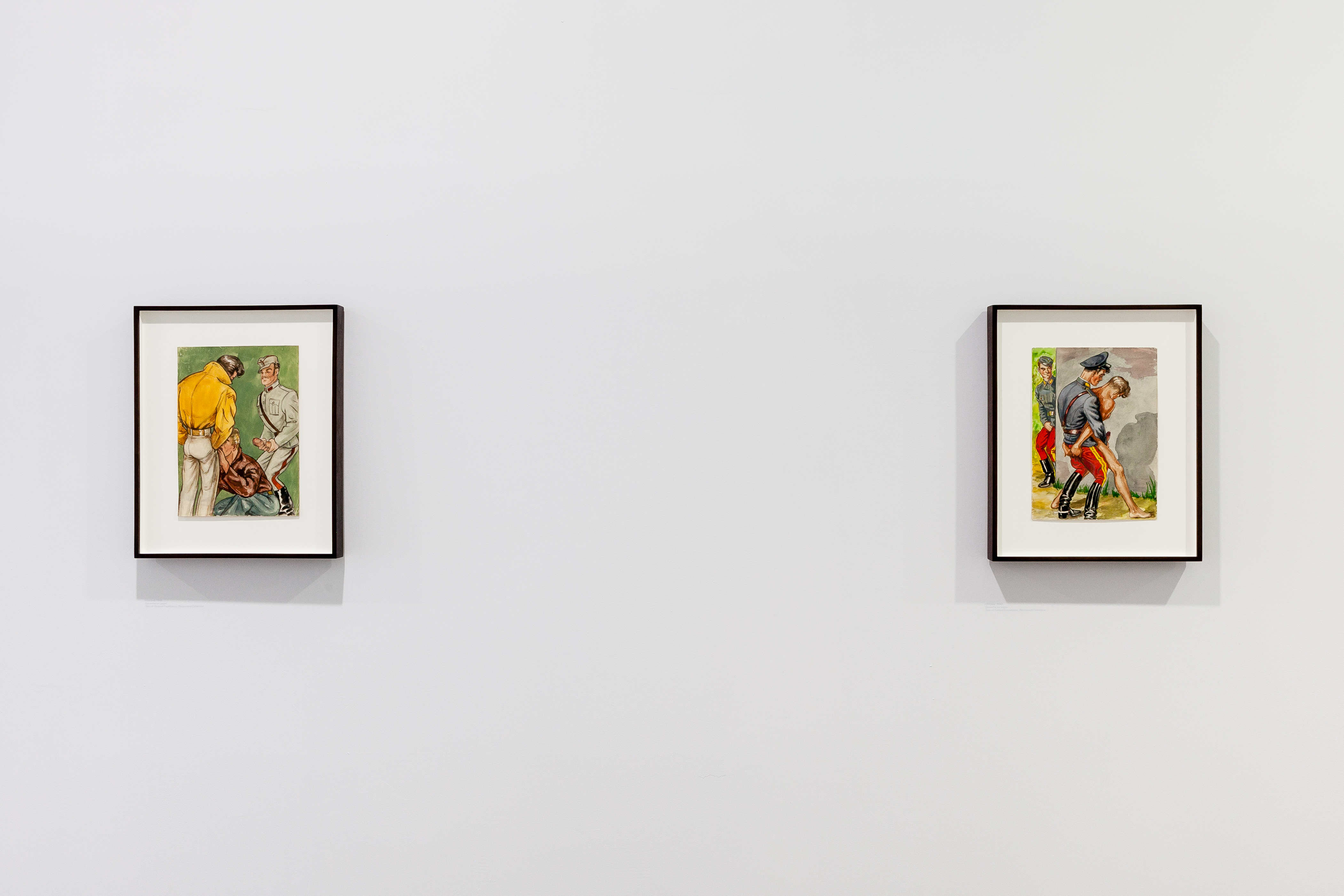 Two color illustrations are framed on a wall. On the left, a man performing oral intercorse to another man as a man in uniform watches in the background, gripping his penis. On the right, a man in uniform has intercoarse with a half-naked man, as a man in uniform watches from around the corner.