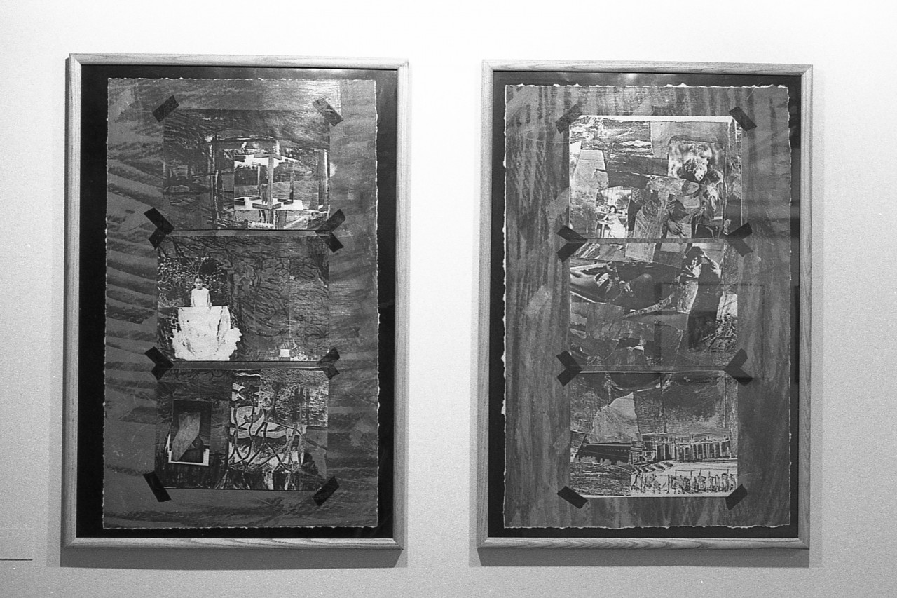 A black and white photograph of two mixed media collage works hanging side by side on a gallery wall.
