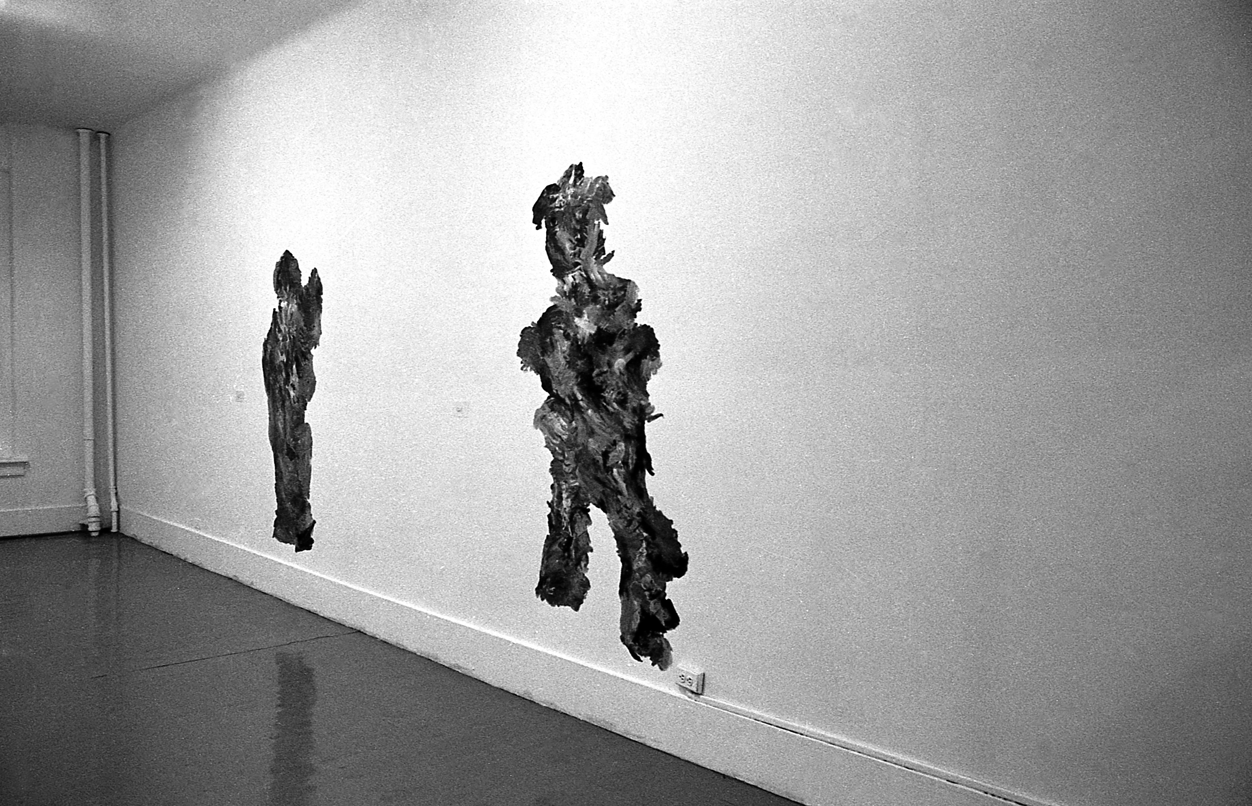 Two pieces hang on a wall.