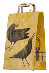A yellow paper bag with handles, detailed illustrations across its sides. At the front is a drawing of two large crows. Intricate line designs in the background and along the handles. On the side of the bag is a barren tree, with small dots indicating snowfall, and a fence that stretches in the background.