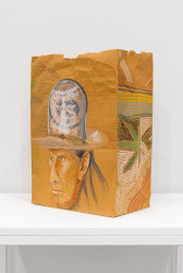 A brown paper bag, placed on a shelf at an angle, an illustration, in colored pencil, of a man wearing a ten-gallon hat, in which his strands of black hair stick out from the bottom. A graphic that reads, 