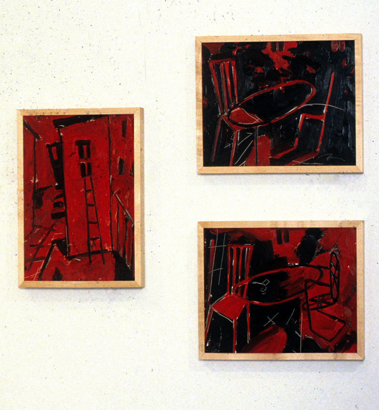 Three figurative, red and black gestural paintings hang on a white wall.  On the left, a vertical work shows the exterior of a building with a ladder leading to a window.  On the right, two horizontal works hung one above the other feature pairs of chairs, each connected by a circle.