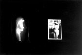 On the left one can see a bright image of a man standing profile view and on the right appears a photograph of a naked woman shielding her face. Blackness surrounds these two images.