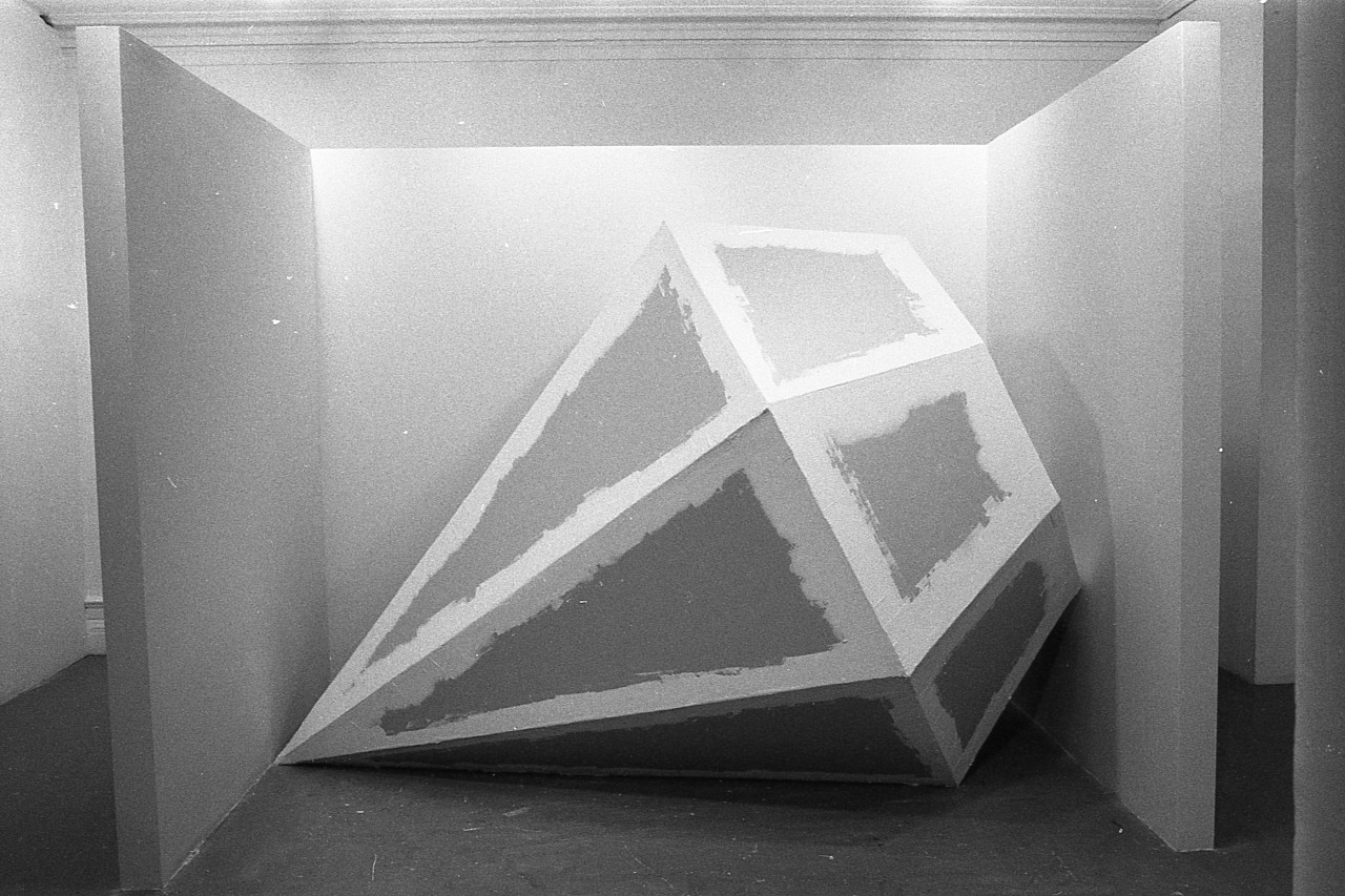 Detail of diamond-shaped sculpted object in its square container.