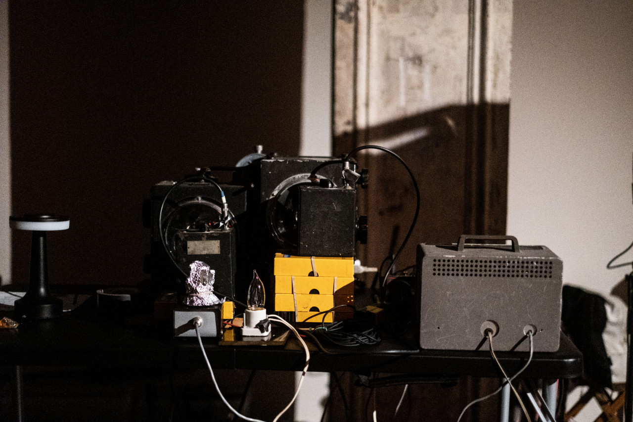 Audio equipment is arranged in stacks across a desk.