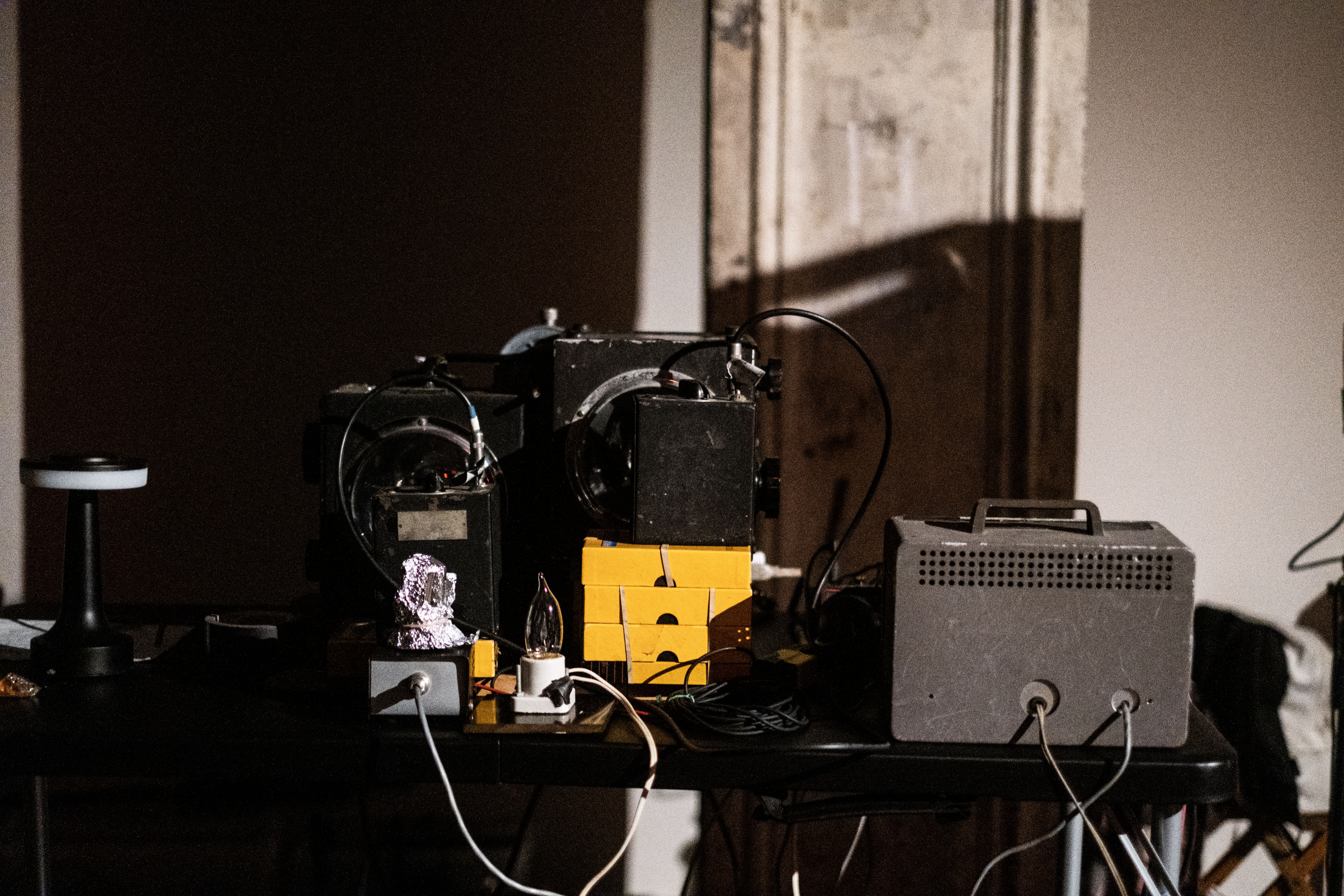 Audio equipment is arranged in stacks across a desk.