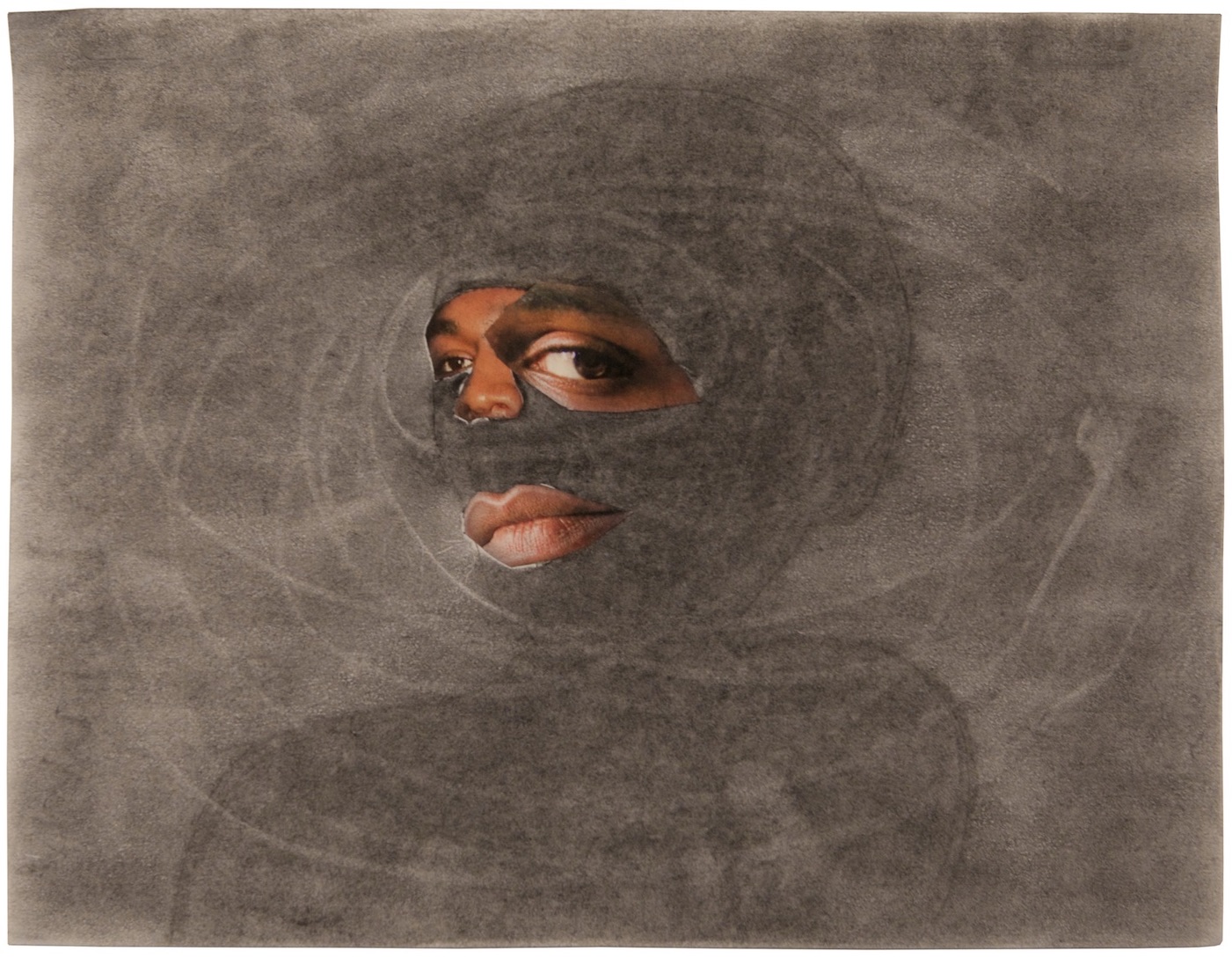 A swirling cloud of grey mist covers most of a figures face. Slivers of their eyes and mouth are revealed through holes in the blanket of grey.