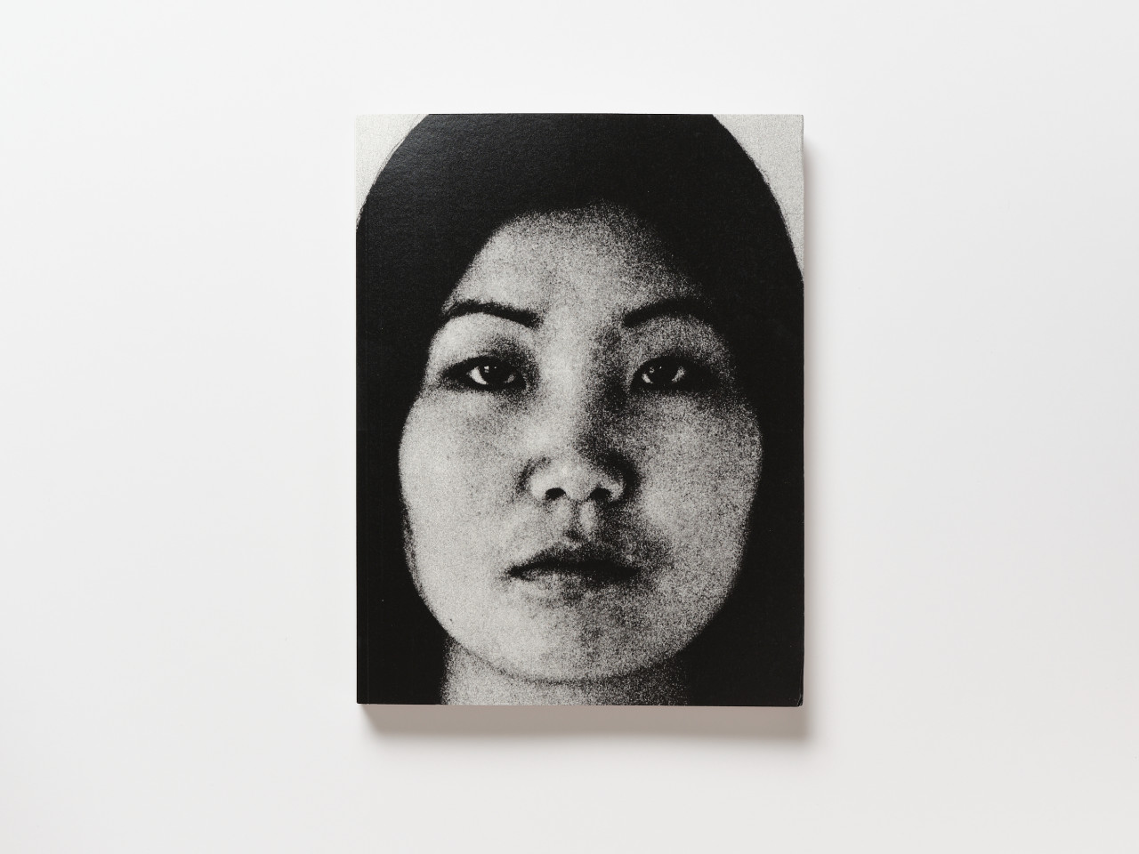 A book cover featuring a black-and-white photograph of a woman