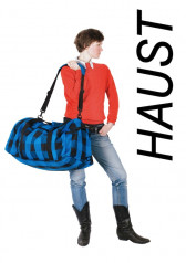 A woman holding a large blue bag. To her right, vertical black text reads, 