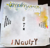 A piece of stretched cloth covered with painted words reading, 