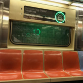 A few empty seats on an NYC subway - the 6 train, with the originating station titled 