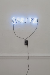 White LEDs hung on a white wall spelling 