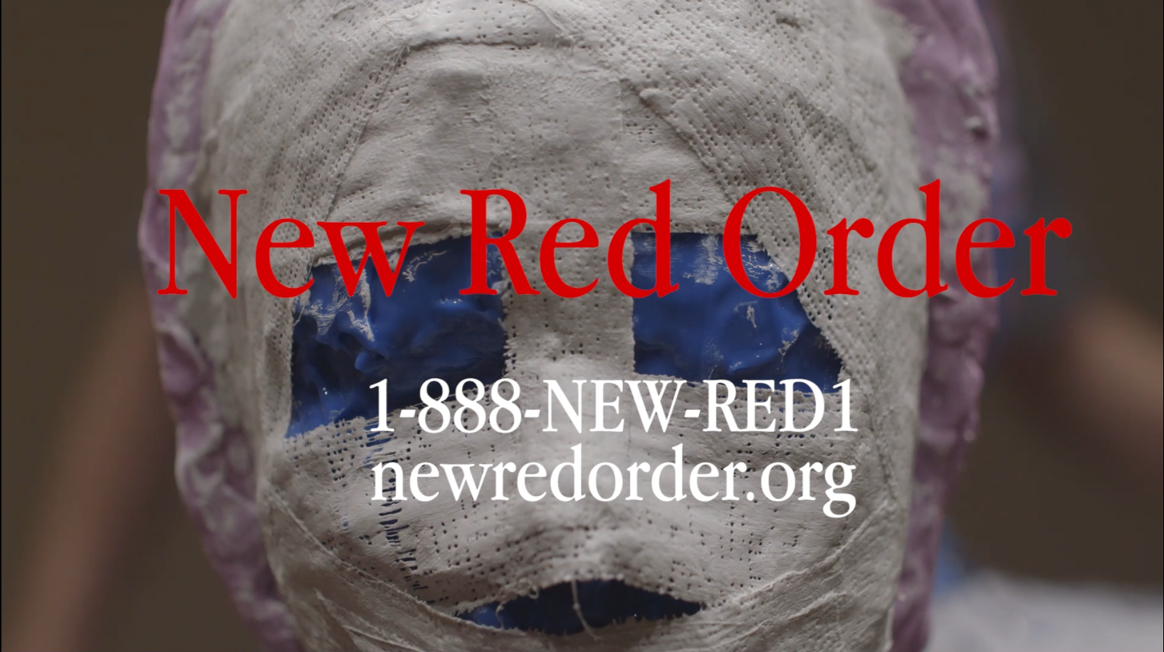 Red text reading “New Red Order” and white text reading “1-888-NEW- RED1 newredorder.org” are overlaid on an image of a face obscured with white plaster.