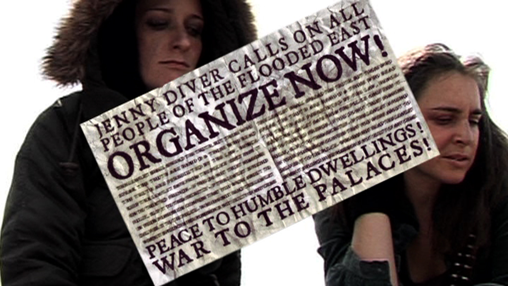 Two people dressed in black looking down. Superimposed on top of them is a poster reading, "JENNY DIVER CALLS ON ALL PEOPLE OF THE FLOOD EAST ORGANIZE NOW! PEACE TO HUMBLE DWELLINGS! WAR TO THE PALACES!"