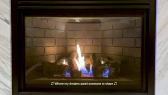 A gas fireplace turned on is framed with a strip of faux white marble on either side. The flames are yellow and white with glowing orange embers at their base. A yellow caption appears at the base of the fireplace with the following text in between musical notes: Where my dreams await someone to share.