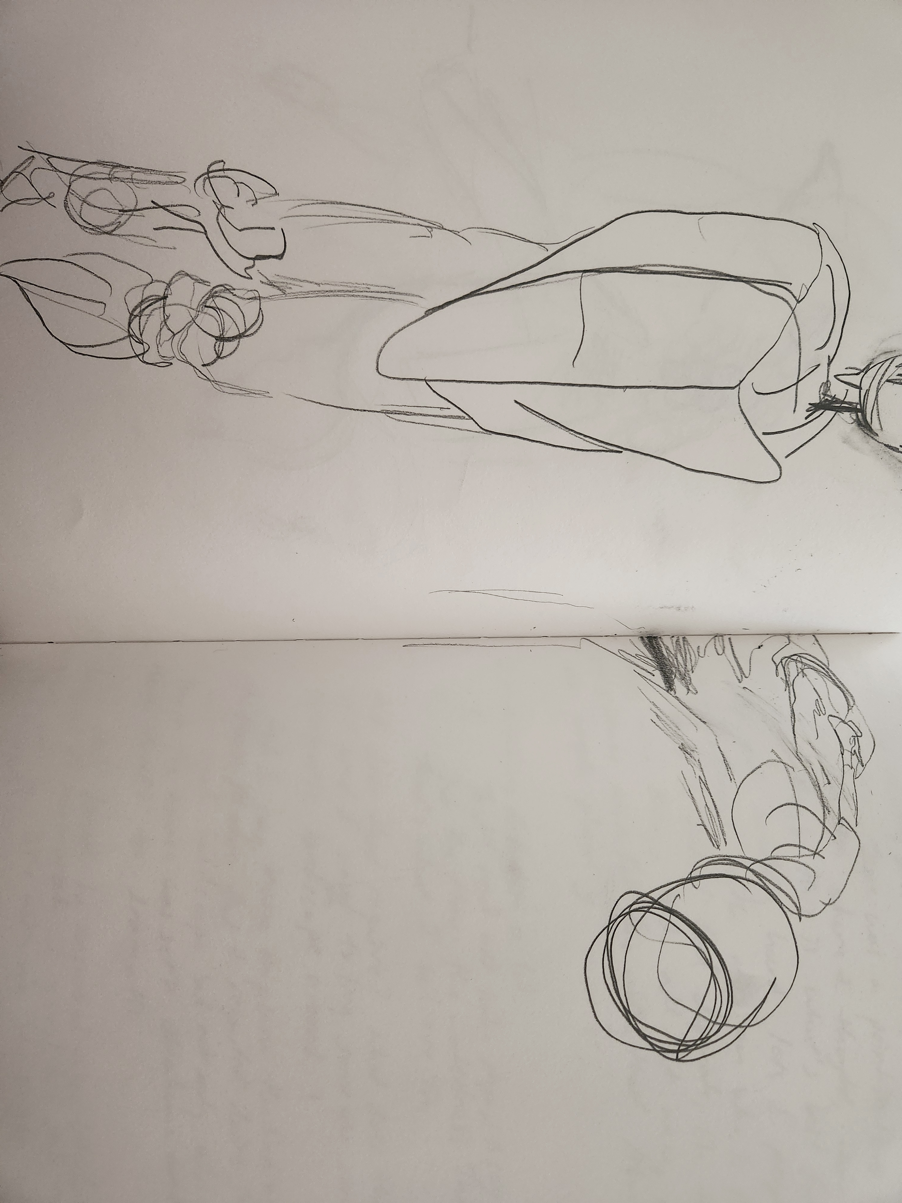 A notebook spread featuring pencil drawings on paper.