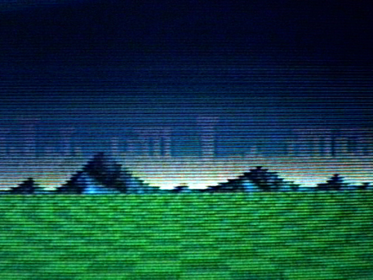 A digitally rendered image of a green with mountains in the background, pixellated with horizontal lines.