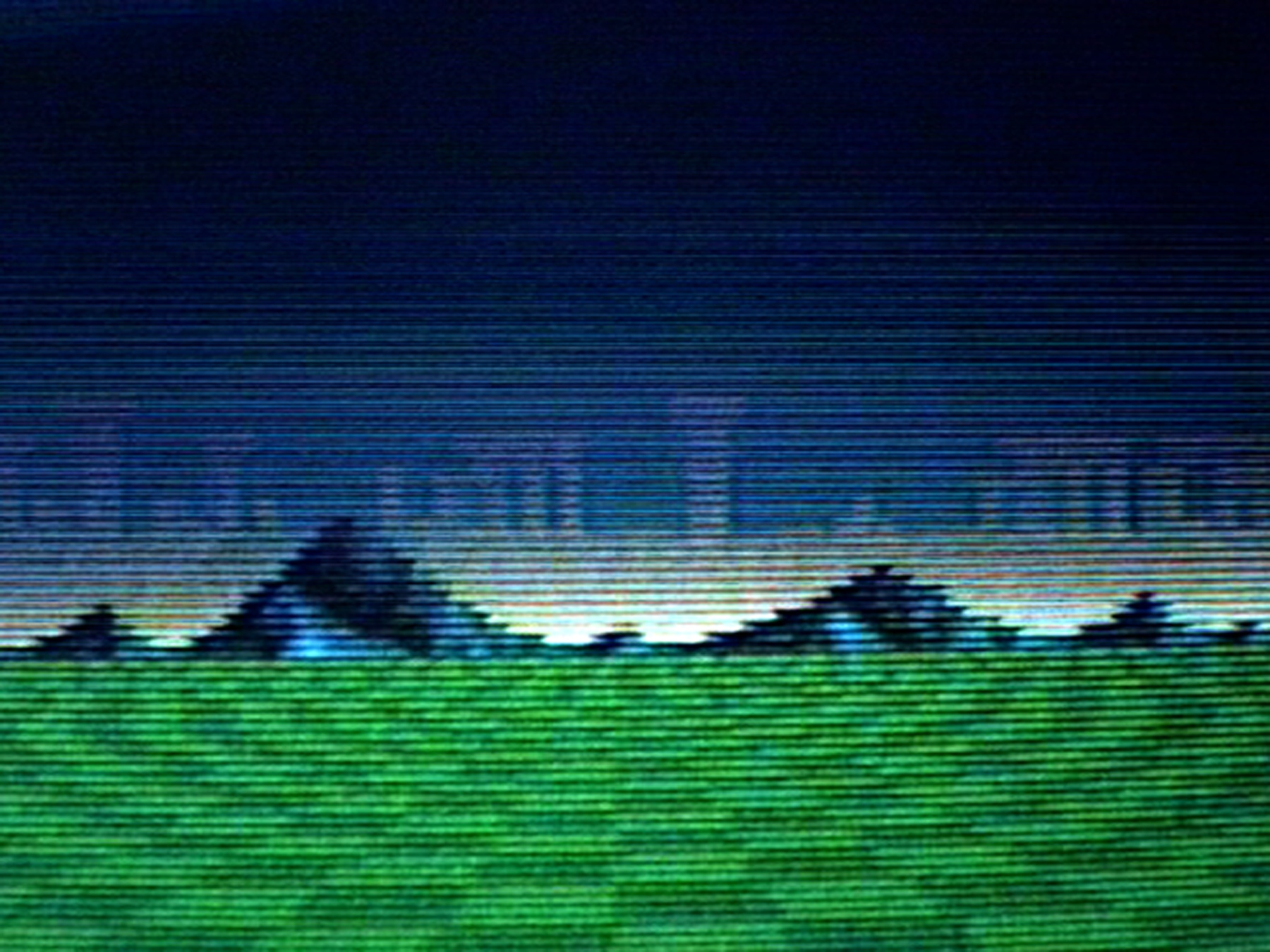A digitally rendered image of a green with mountains in the background, pixellated with horizontal lines.