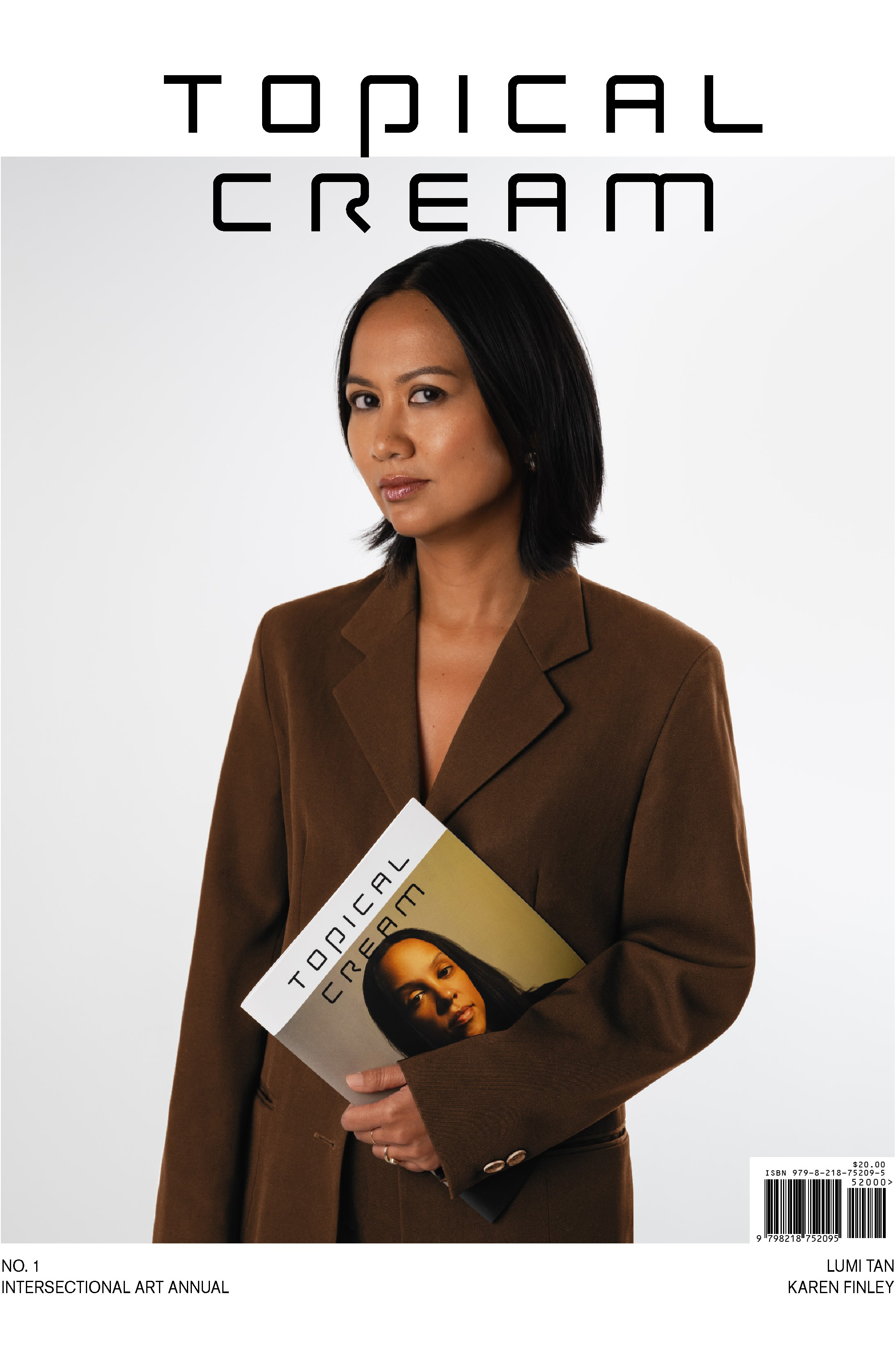 Magazine cover featuring a photograph of a woman in a brown blazer against a white background. She holds a magazine in her right hand. Text across the top reads 