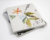 A portfolio box with a flowered pattern on the lid is shown on a white ground with the lid slightly askew.